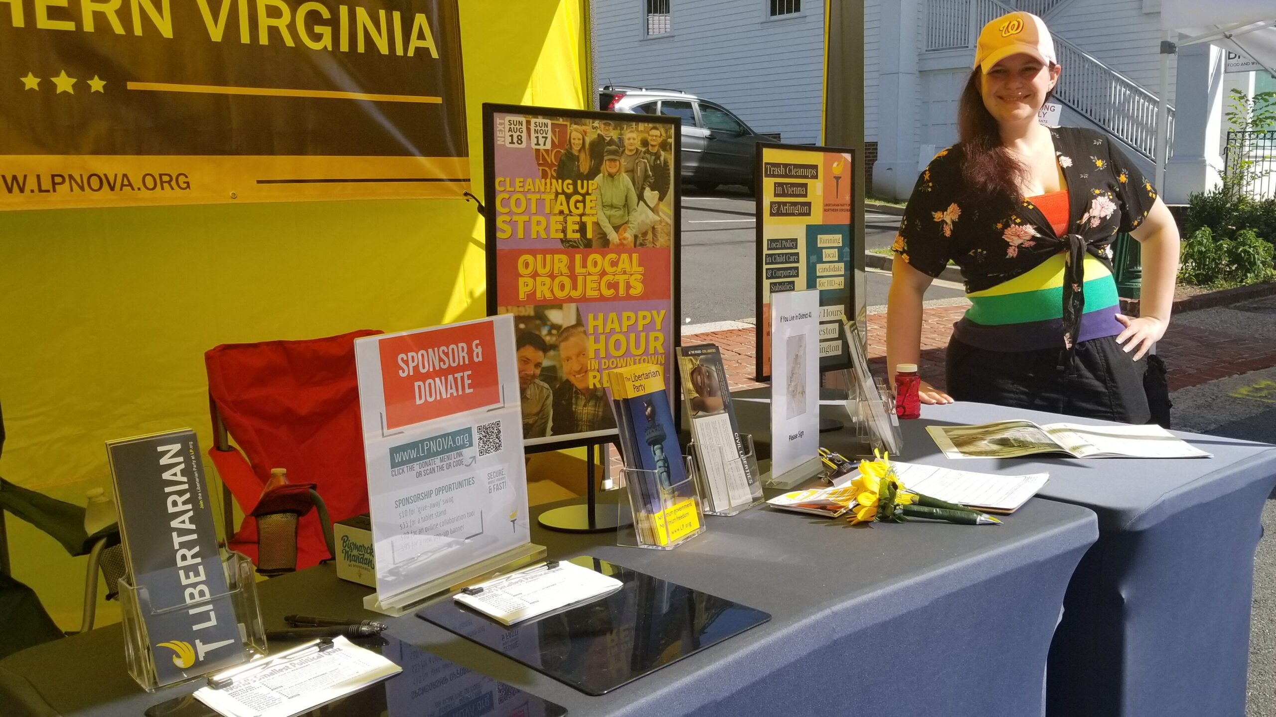 LPNOVA's outreach booth with tabletop displays and interactive games